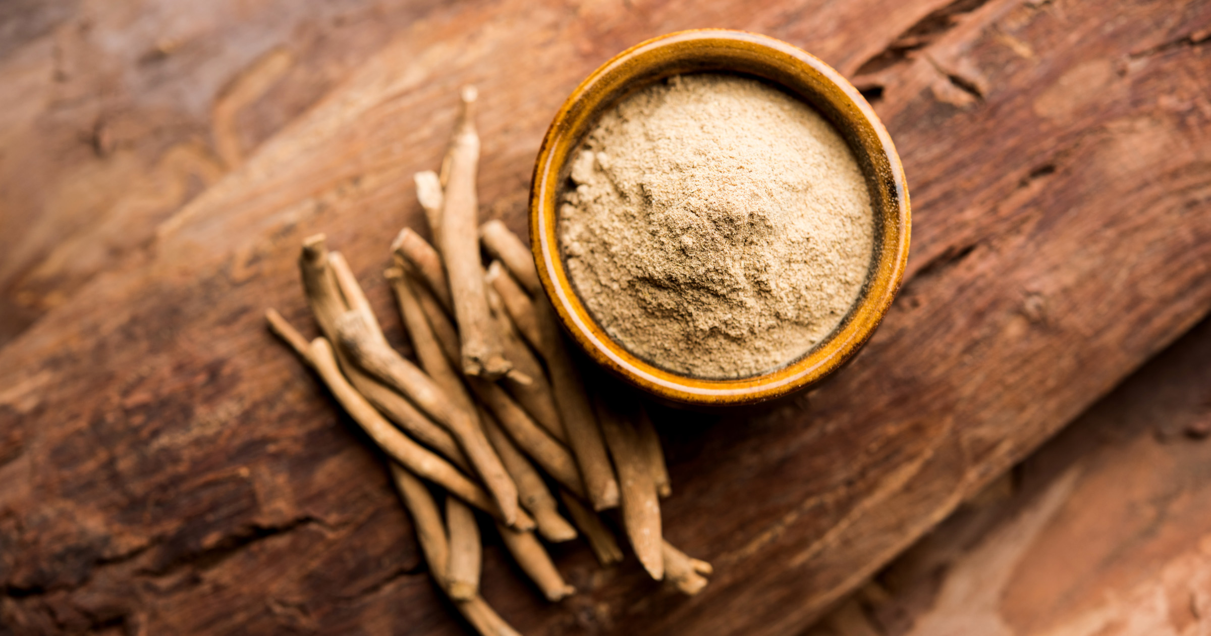 Ashwagandha Benefits: Ashwagandha powder and roots on a natural surface